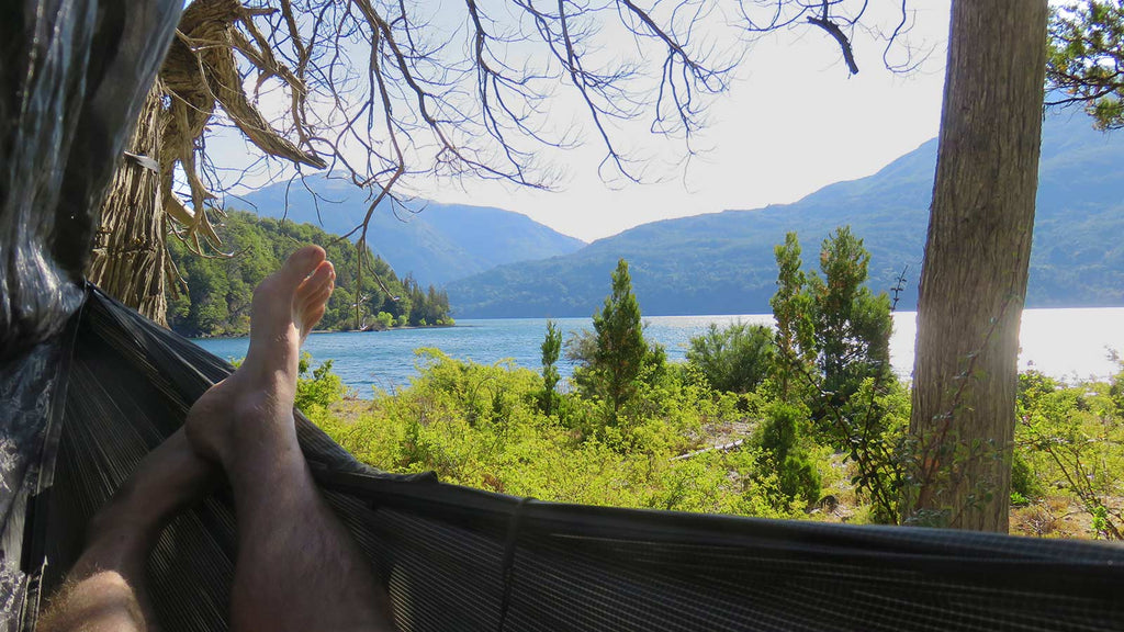 laying in Hennessy hammock on lake